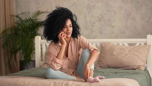 Portrait Cute African American Woman Talking on Her Smartphone and Smiling Happily alt