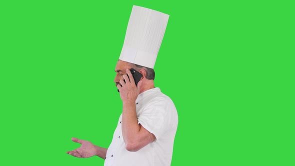 Male Chef Cook with Calling on Smartphone on a Green Screen Chroma Key alt