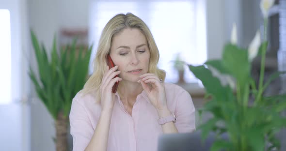 Stressed businesswoman making phone call