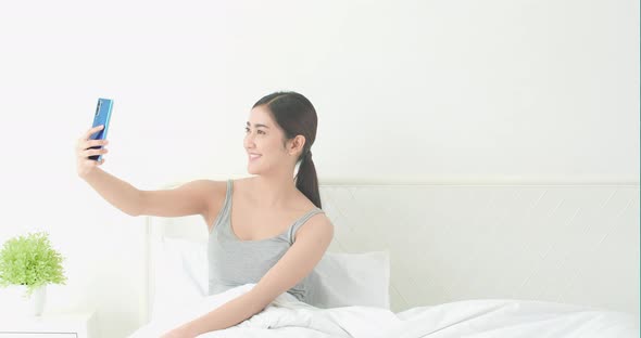 Woman selfie with smartphone alt