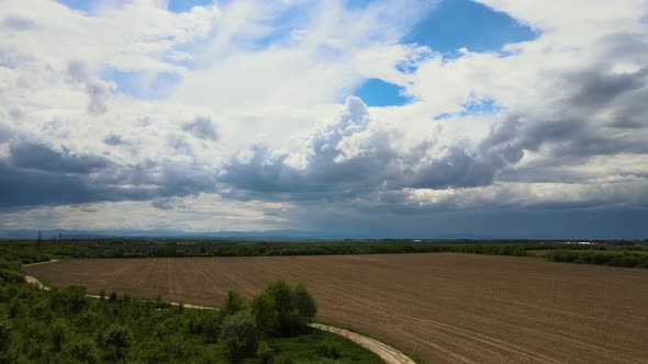 Landscape of Dark Clouds Forming on Stormy Sky During Thunderstorm Over Farmlands alt