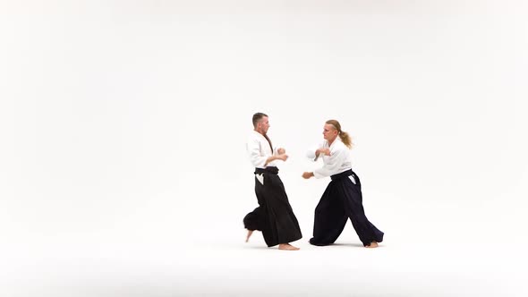 Two Men in Kimono Demonstrating Aikido Techniques, Isolated on White alt