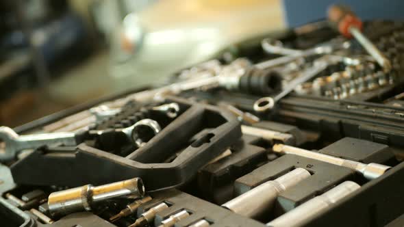 Auto Mechanic Takes a Tool in Mechanics Garage