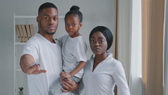 Serious Afro American Family Parents with Little Daughter Child Kid Girl Standing Looking at Camera alt