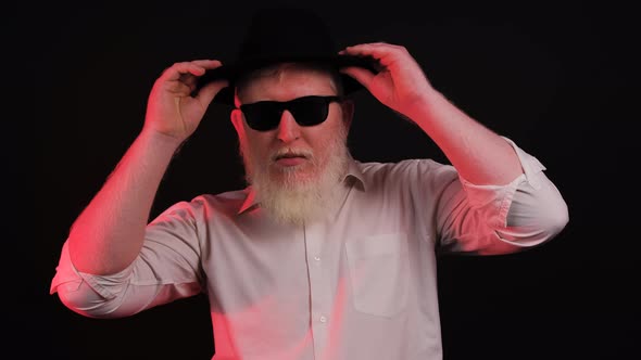 Portrait of a Bearded Man with Albnism That is Posing Over Black Background alt