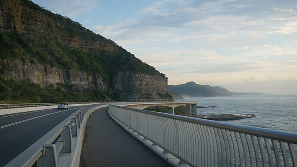 Sports Car Driving across along Sea Cliff Bridge