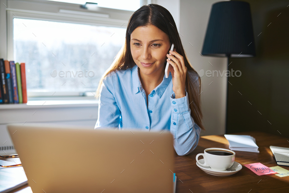 Cheerful young adult business owner on phone - Stock Photo - Images