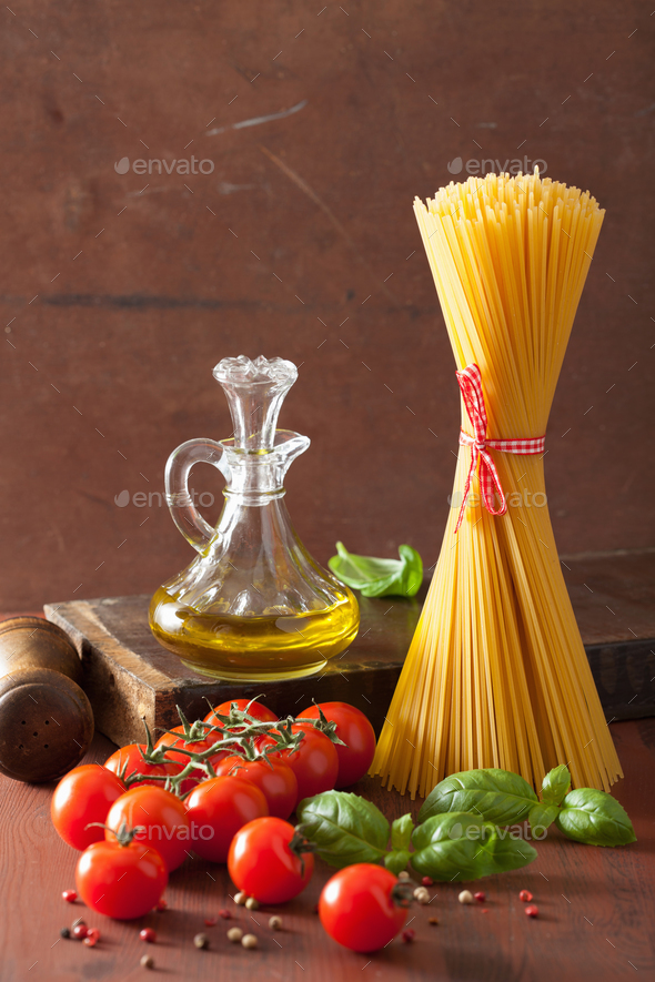 raw pasta olive oil tomatoes. italian cuisine in rustic kitchen Stock