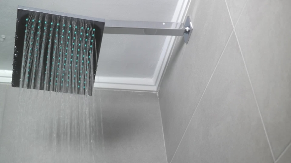 Hot Water Flowing From Square Shower Head alt