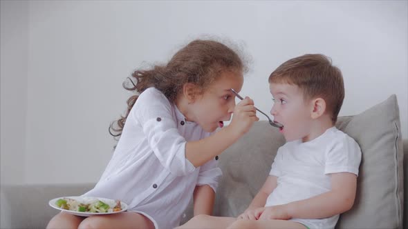 Daughter a Pretty Sister, Nanny with a Younger Brother Are Sitting on the Couch,loving Happy Sister alt