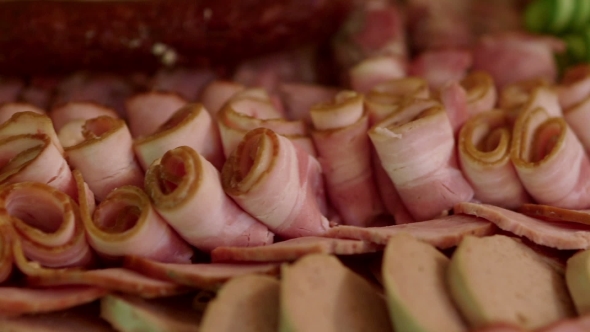 Slices Of Ham And Cucumbers Rolled Up For Party alt