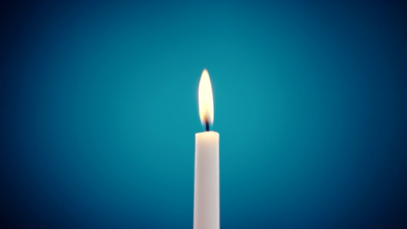 Burning Candle On a Blue Background, Stock Footage | VideoHive