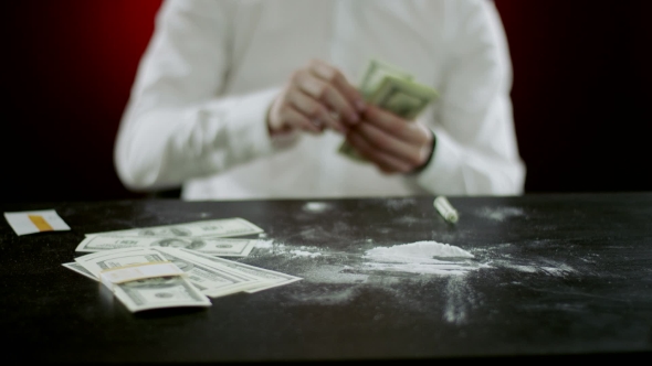 Folding Money On The Table Wiith Cocaine 