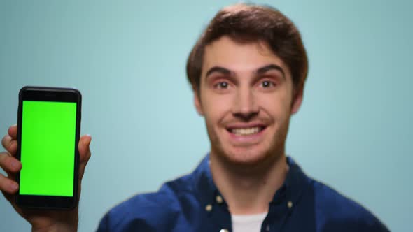 Man Showing Mobile Phone with Green screen.Student Showing Phone with Chroma Key alt