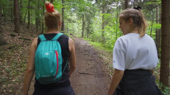 Two Active Climbers Walking Through The Forestland In Carpathian Mountains Alongside The Slovak-Czec alt