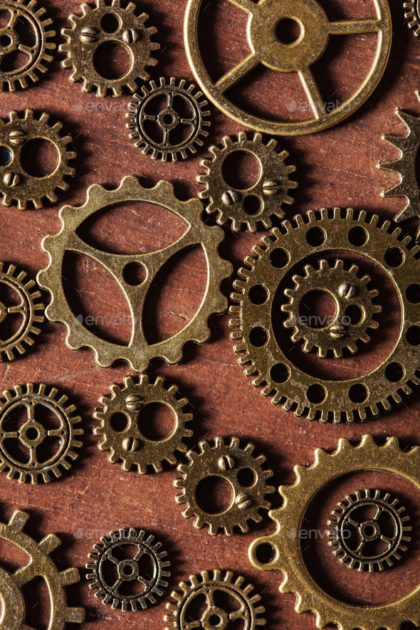 steampunk mechanical cogs gears wheels on wooden background