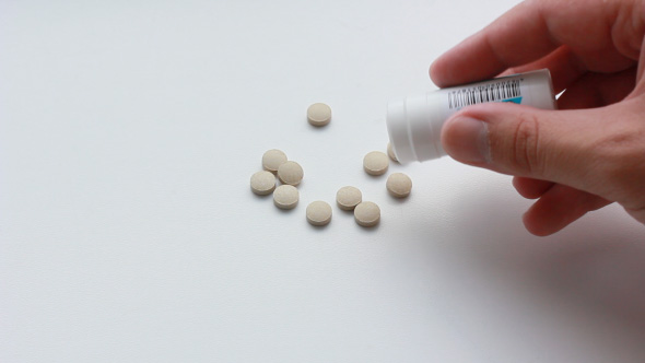 Patient Takes Pills From The Medical Bottle