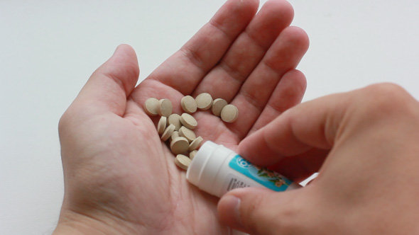 Patient Takes Pills From The Medical Bottle