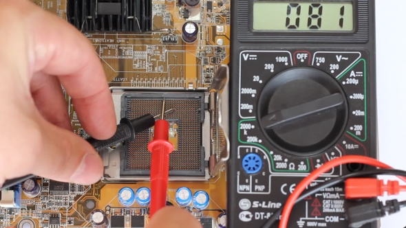Man Measures Digital Millimeter Motherboard And Processor.