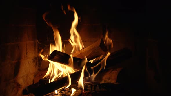 Burning Fire In The Fireplace. Wood And Embers In The Fireplace Detailed Fire Background. alt