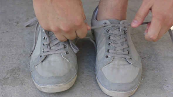 Man Tying The Shoelaces On His Running Shoes