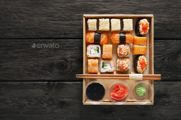 Set of sushi maki and rolls at black rustic wood. - Stock Photo - Images