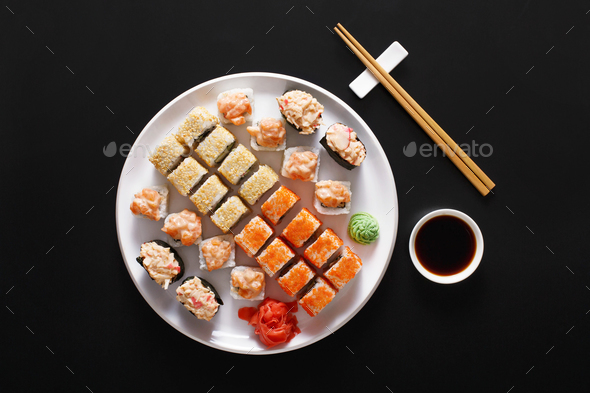 Set of sushi maki and rolls at black rustic wood. - Stock Photo - Images