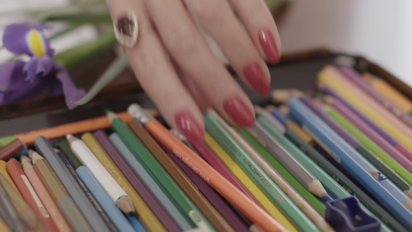 Female Hand Takes a Pencil