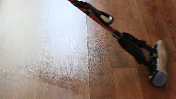 Cleaning The Wooden Floor With Wet Mop