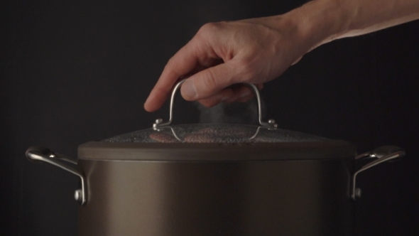 Hand Open Lid On Steaming Pot