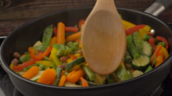 Frying Vegetables On Black Pan 