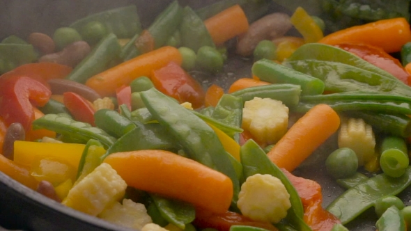 Cooking Vegetables On Black Pan 