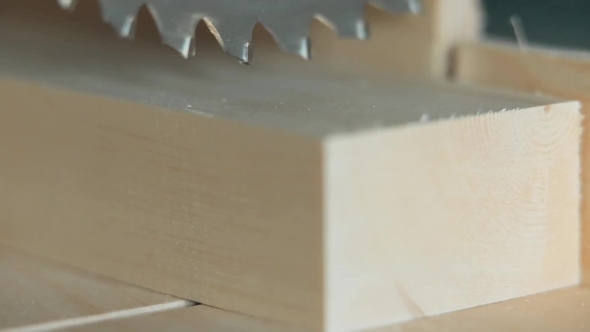 Electric Saw Starts To Saw Off a Piece Of Wood alt