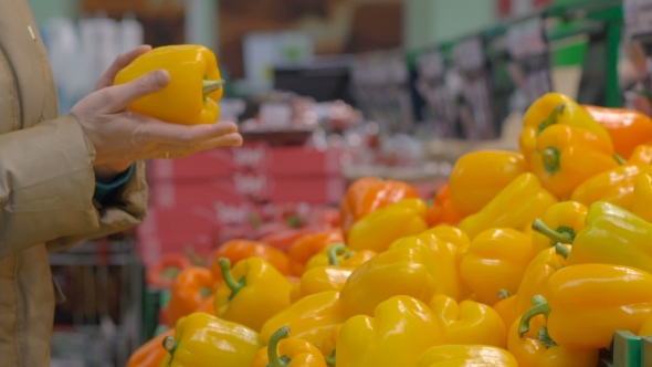 Woman Buys a Bell Peppers In The Store