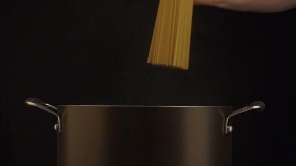 Throwing The Spagetti Into The Cooking Pot