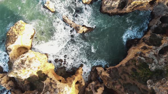 Top view of Atlantic Ocean waves crashing on cliffs. Lagos coastline. Portugal alt