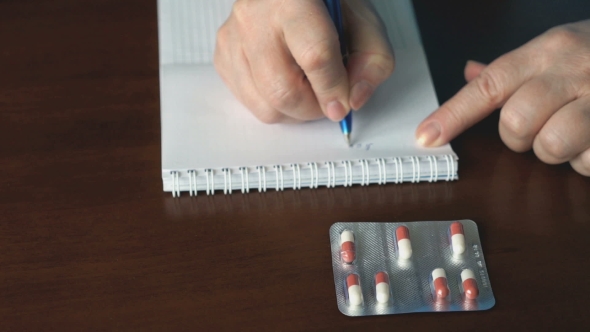 Woman Pushes The Tablet Out Of The Packaging alt