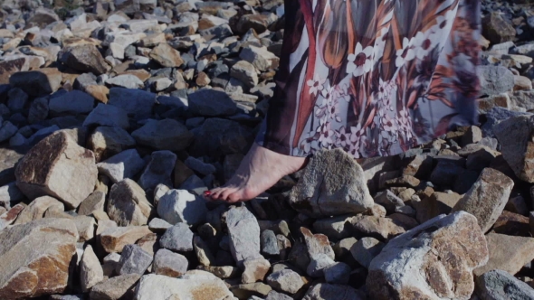  Detail Of a Woman's Feet In a Long Dress Standing On Big Stones alt