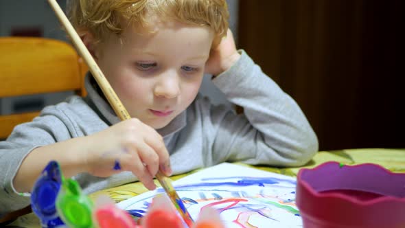 Child Boy Painting On The Paper