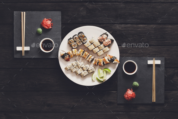 Set of sushi maki and rolls at black rustic wood. - Stock Photo - Images