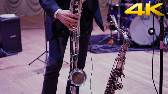 Man Playing on Saxophone on the Stage 4K