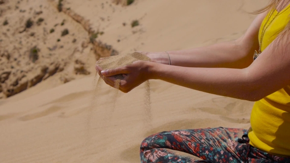 Sand Falling From Woman's Hands alt