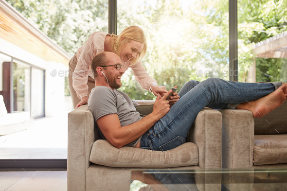 Mature couple at home using digital tablet - Stock Photo - Images