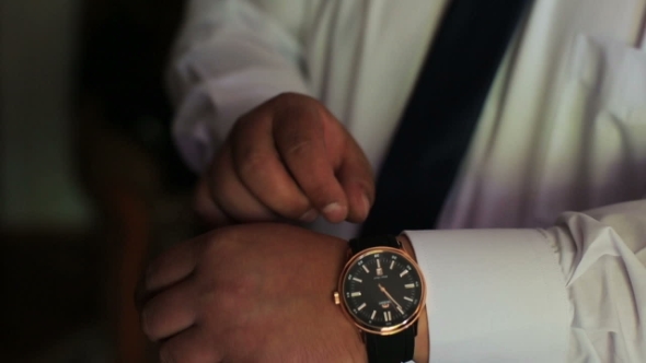 Man Putting On Wrist Watch