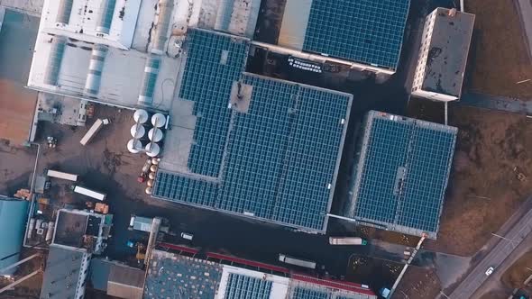 Sunny collectors on the roof of industrial buildings. Solar energy farm. Photovoltaic solar panels f alt