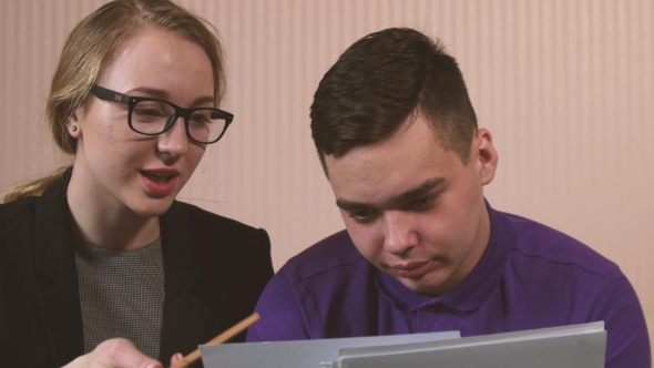 The Young Woman Explains To The Young Man Some Material alt