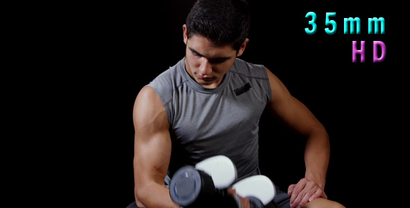 Young Man Doing Curls With Dumbbells