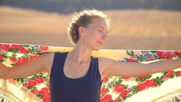 Girl On a Background Of Field In a Strong Wind.