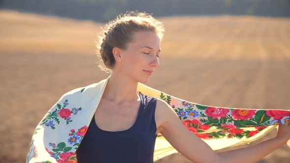 Girl On a Background Of Field In a Strong Wind.