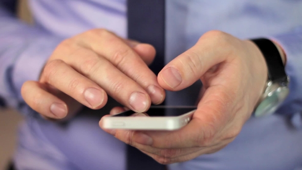 Man's Hands Using Mobile Phone Touchscreen 1